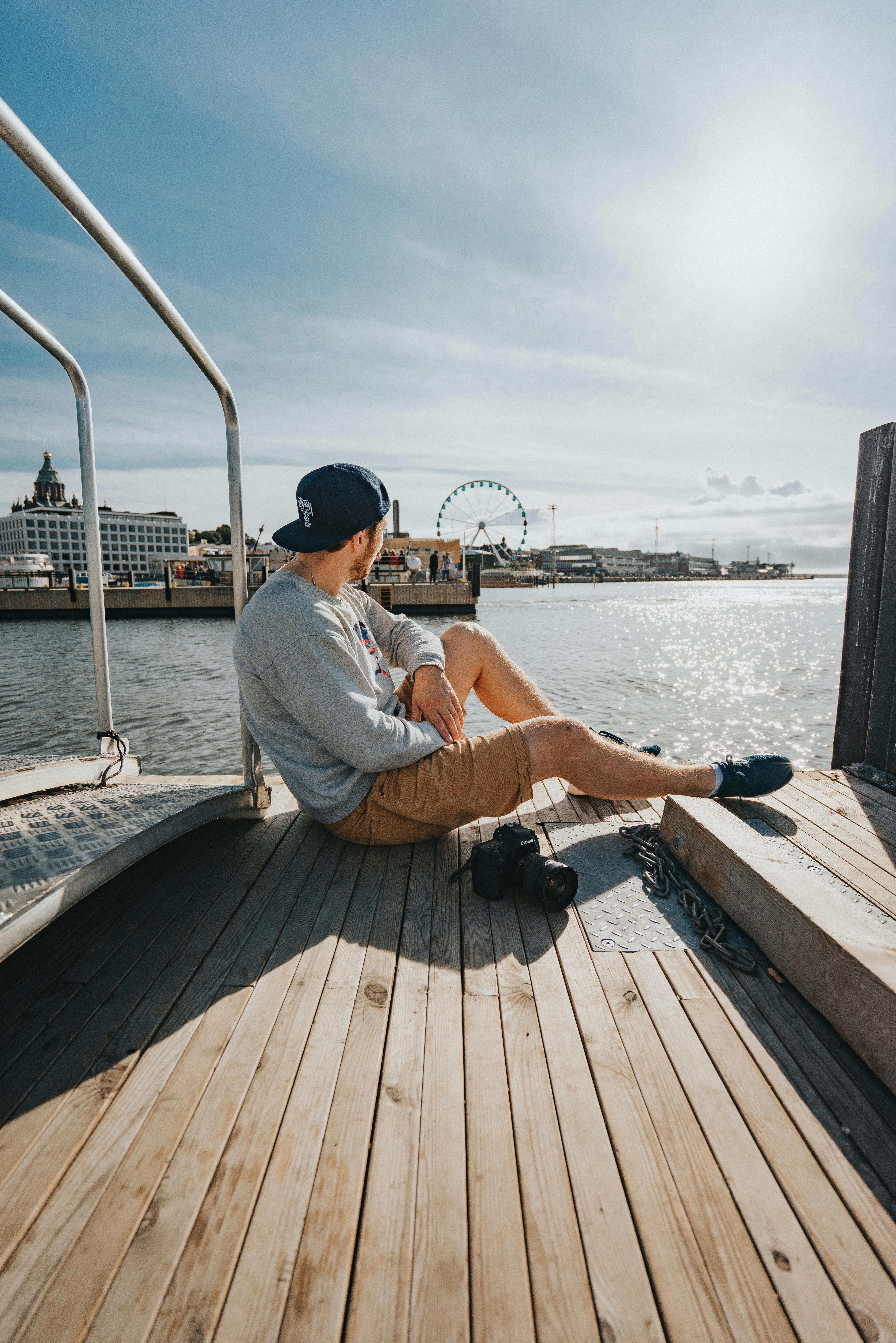 person sitting on dock